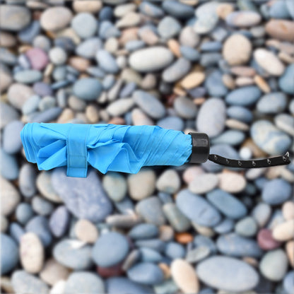The DrizzlePro 3-fold umbrella neatly packed in its protective sleeve, ready for compact storage.