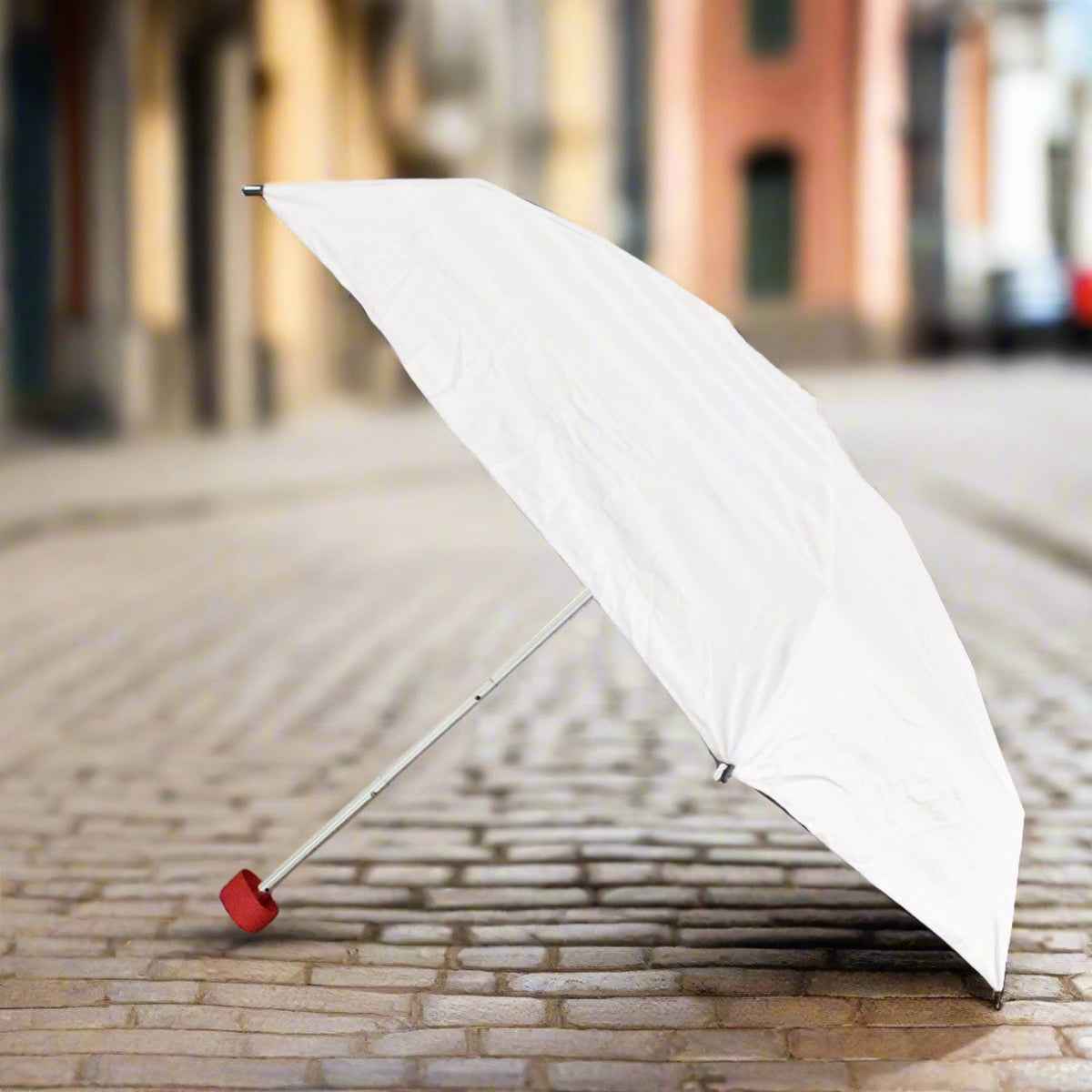 Compact DrizzlePro foldable umbrella closed, ready for travel.
