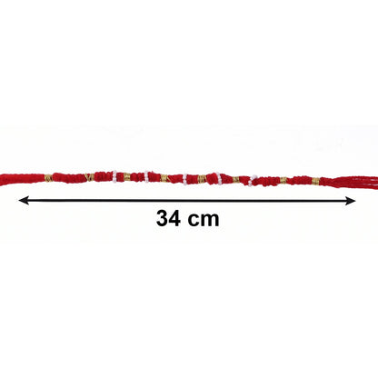 Close-up of red rakhi with beads and pearl accents