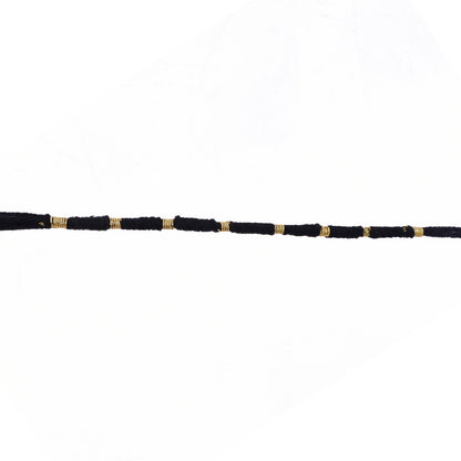 Red Mauli rakhi with gold and pearl details for festival
