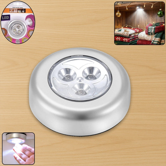 Round white cordless LED touch light with adhesive backing.