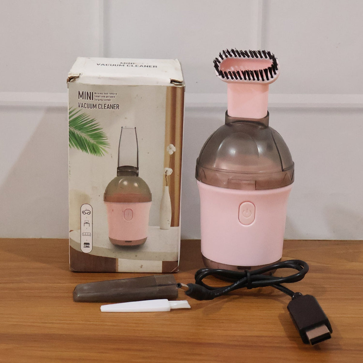 Mini vacuum cleaner in use on various surfaces