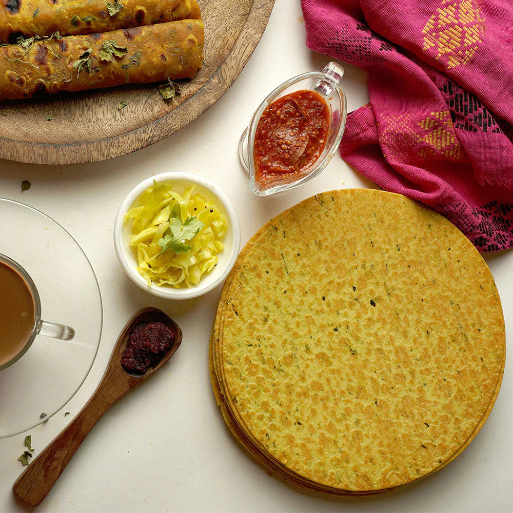 Stack of thin, round fenugreek wheat crisps, ready for snacking.
