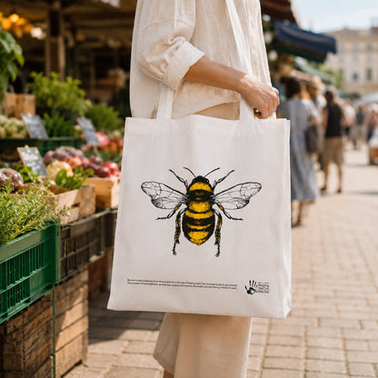 Woman carrying bee print tote bag at market